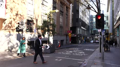 people crossing street at traffic light in melbourne