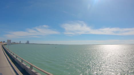 pov out the passengers window while driving on queen isabella causeway over the laguna madre at south padre island, texas