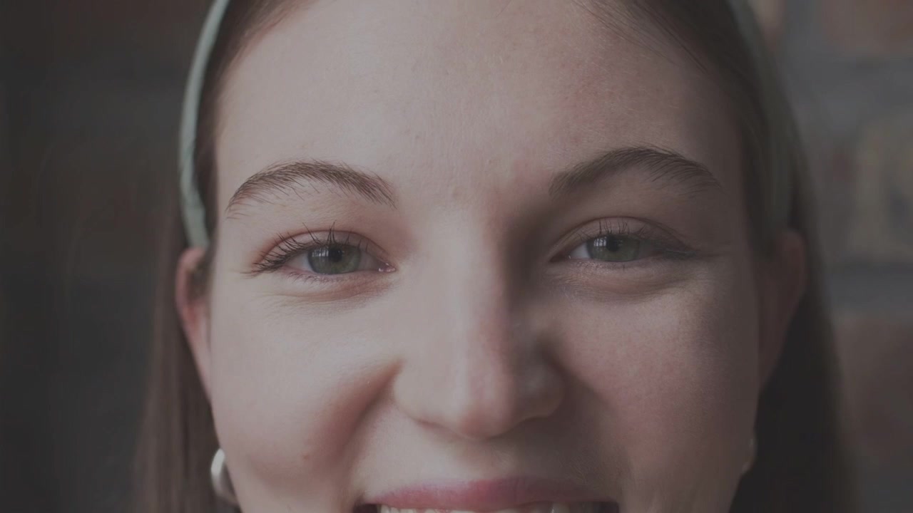 Female subject blinking, opening eyes and smiling for marketing, scan lines overlaying frame