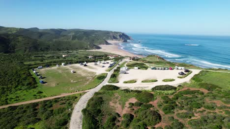 large parking lot above beachfront of praia do amado near carrapateira in algarve, portugal. aerial shot