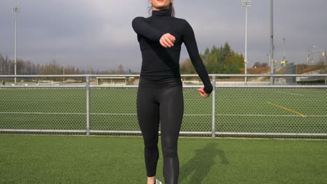 young sporty caucasian brunette exercising at the sports field slomo