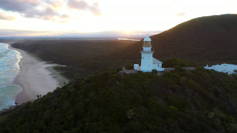 Cinematic-revealing-drone-shot-of-sunrise-at-Smoky-Cape-Lighthouse-near-South-West-Rocks,-Kempsey-Shire,-New-South-Wales,-Australia