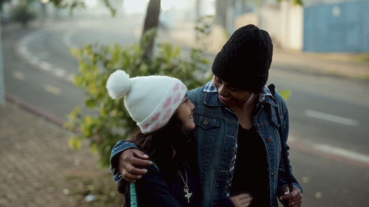 A Mother and Daughter Walking and Bonding on a Street