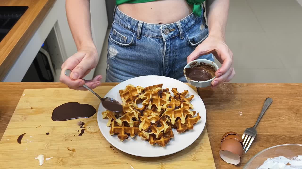 Making waffles with chocolate topping