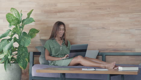 woman using laptop computer on daybed