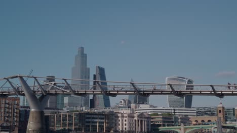 a evry quiet morning on the millennium footbridge crossing the river thames london