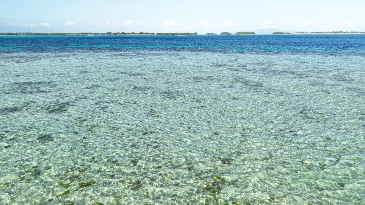 Bora Bora Island Lagoon and Coral Reefs, Drone Shot of Water and Luxury Resorts on Horizon, French Polynesia