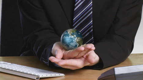 businessman with a rotary globe in his hand