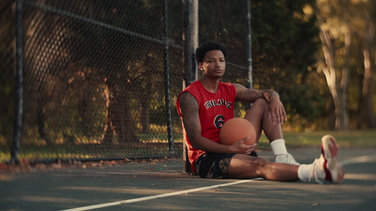 Young Basketball Player Resting on the Court