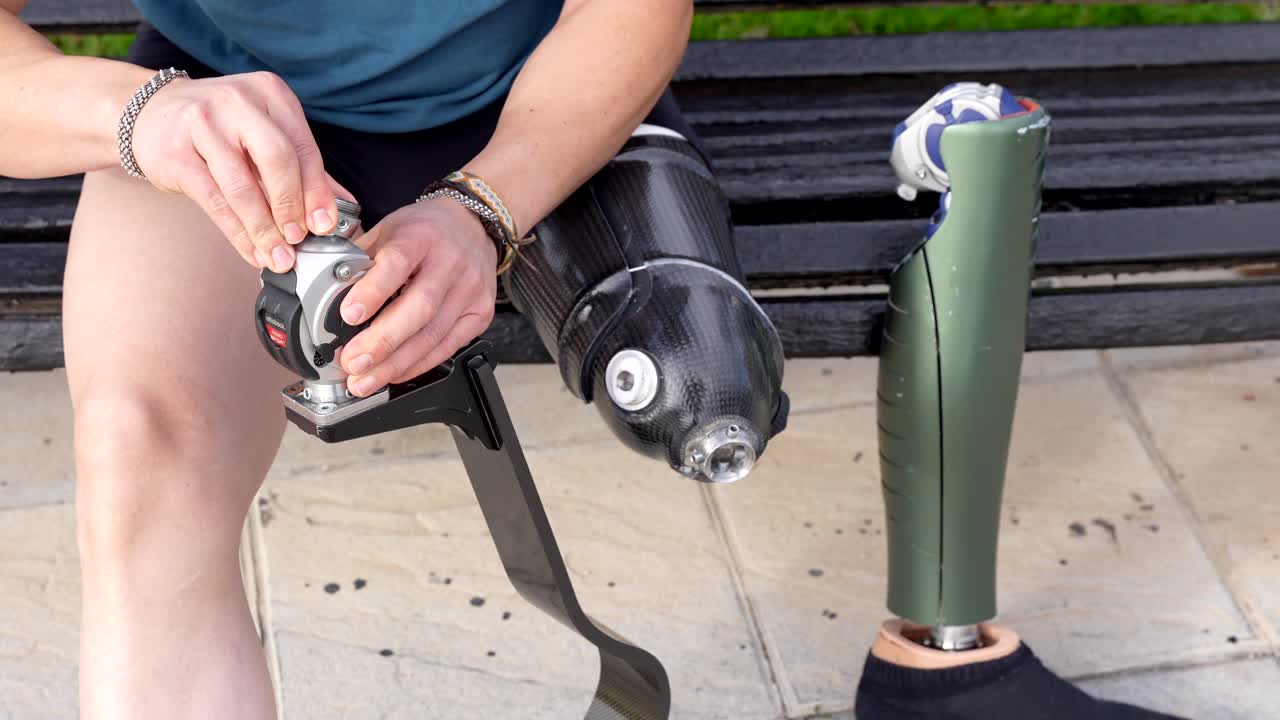 A woman adjusting her prosthetic leg with a screwdriver