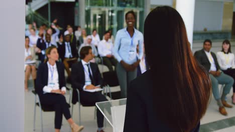 female speaker speaks in a business seminar 4k