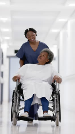 vertical video of senior african american woman and female doctor, slow motion, copy space