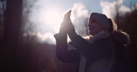 technology woman using smartphone to take picture in autumn 4