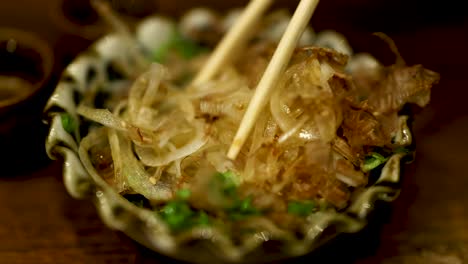 chopsticks picking up japanese dish in dubai