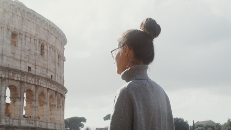 Woman admiring the Colosseum in Rome