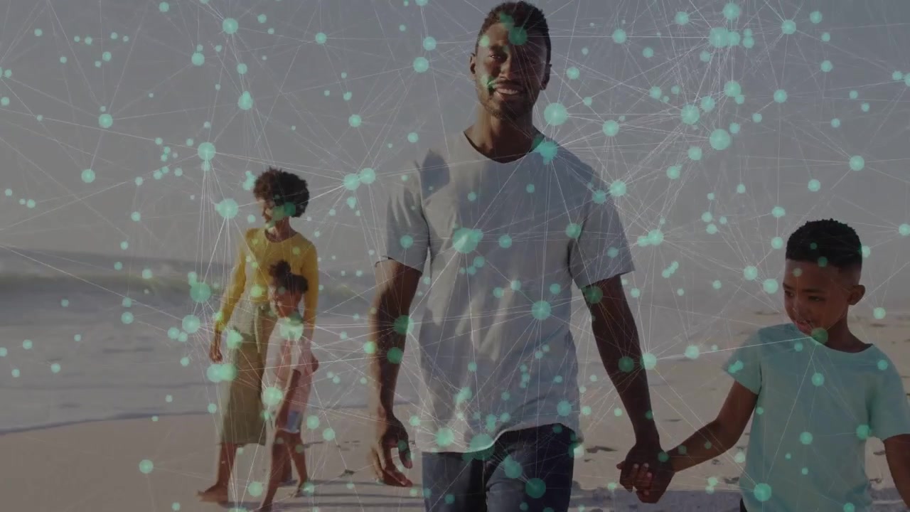 Walking toward camera, man and boy holding hands on beach, starting turquoise overlay showing tech