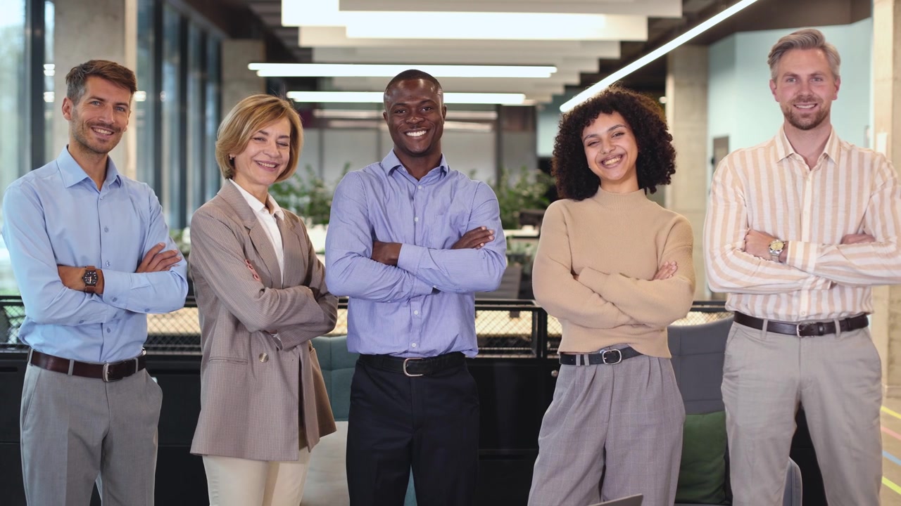 Diverse Business Team Standing and Smiling Confidently in Modern Office
