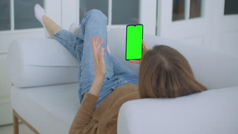 Phone-with-Green-Screen-and-Chroma-Key-Closeup.-Chromakey-Mockup-with-Tracking-Markers-and-Alpha-Matte.-POV-is-Vertical-Template-of-Device-in-Modern-House-Closeup.-Scroll-Up-Online-News-at-Cellphone