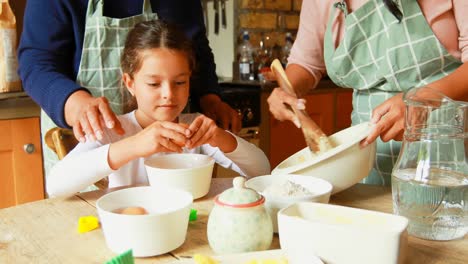 girl preparing food with family in kitchen 4k