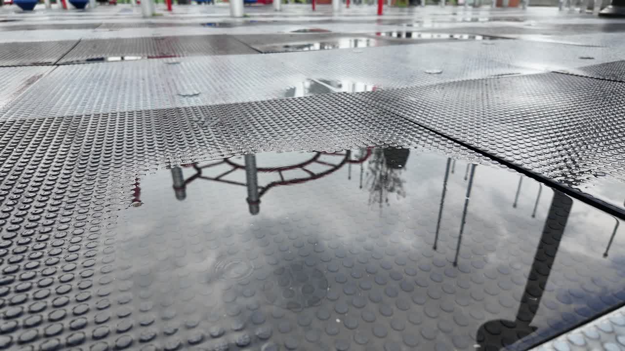 Puddle Reflection on Playground Floor