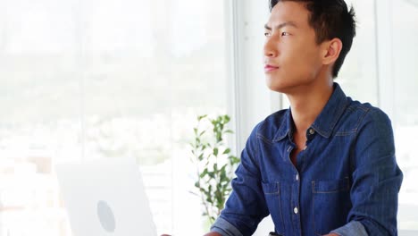 Man-thinking-using-laptop