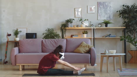 woman in vr headset stretching at home