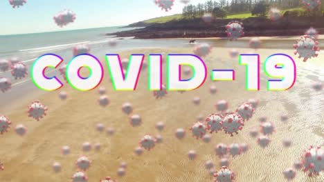 digital composite video of covid-19 text and cells moving against beach in background