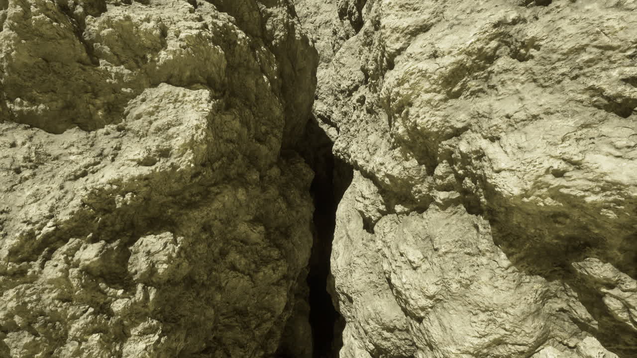 Crack between large rock formations in a natural landscape during daylight