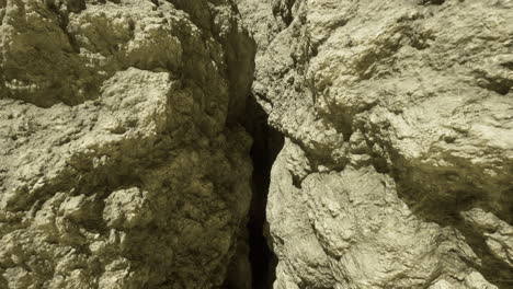 crack between large rock formations in a natural landscape during daylight