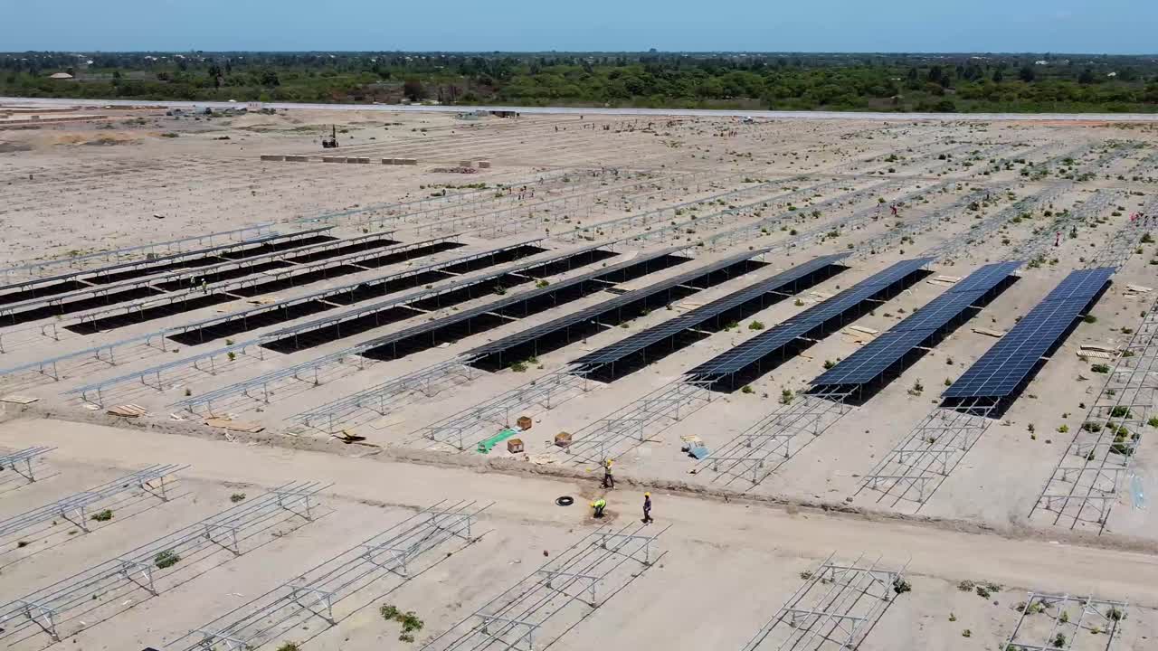 Aerial view of solar photovoltaic farm power plant with solar panels under construction in Jambur, Gambia