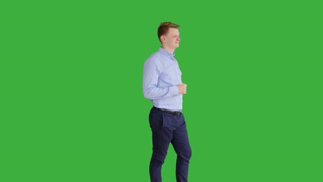 young caucasian man standing against green screen background. male person isolated on chroma key. casual business professional portrait