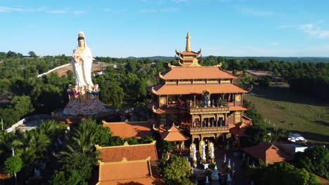 beautiful rural buddhist temple surrounded by palm tree forest in southeast asia