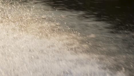 Slow-motion-shot-of-spray-coming-off-the-side-of-a-boat