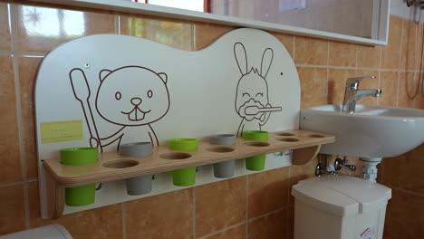 sink, cute rack for toothbrushes in kindergarten classroom