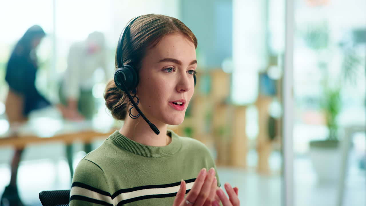 Woman in headset working at office desk