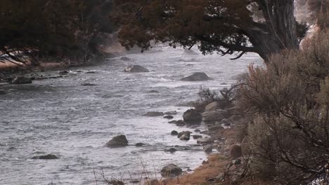 a stream flows over rocks in winter