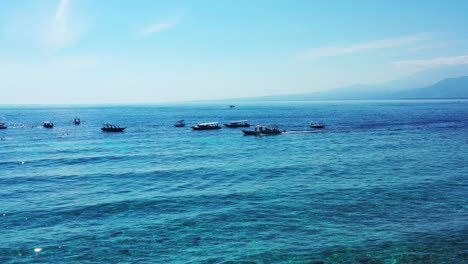 Boats-floating-in-the-open-ocean-on-beautiful-sunny-day