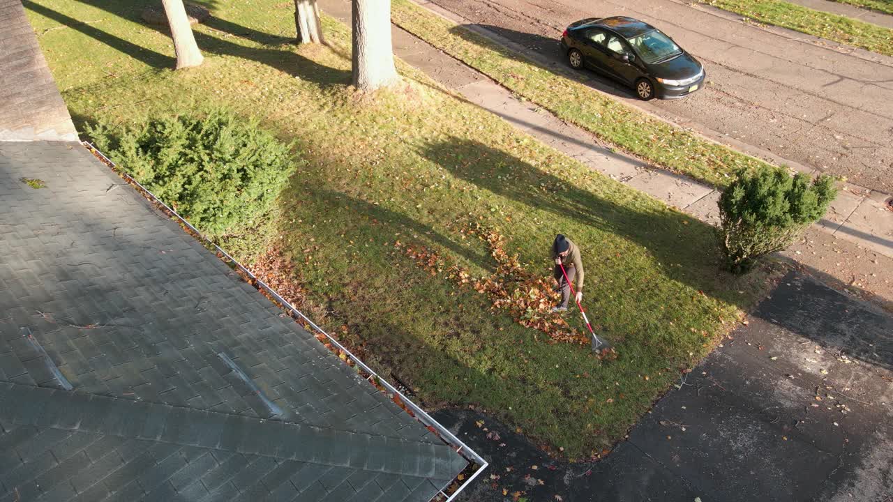 Raking leaves into a small pile in Autumn