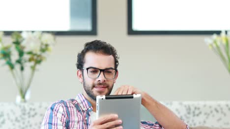 Happy-young-man-using-his-tablet