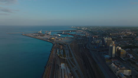 Forwards-fly-above-waterfront.-Railway-tracks-and-roads-leading-to-harbour-in-sea-coast.-Port-Elisabeth,-South-Africa