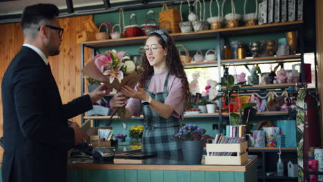 customer buying flowers in a floral shop