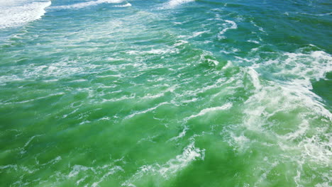 tumultuous ocean waves running onto shore at historic cape l'agulhas, aerial