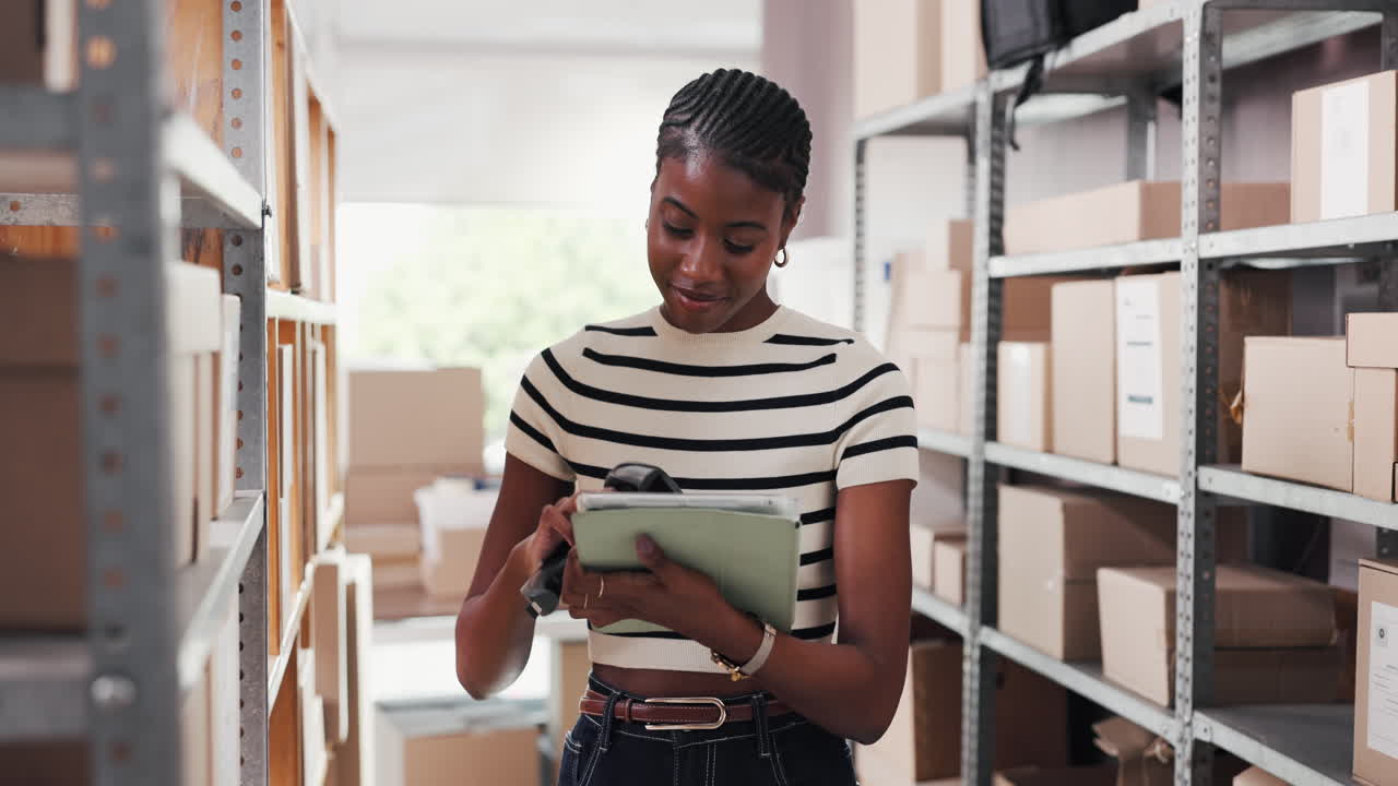 Young Black Woman Checking Inventory on Tablet in Warehouse