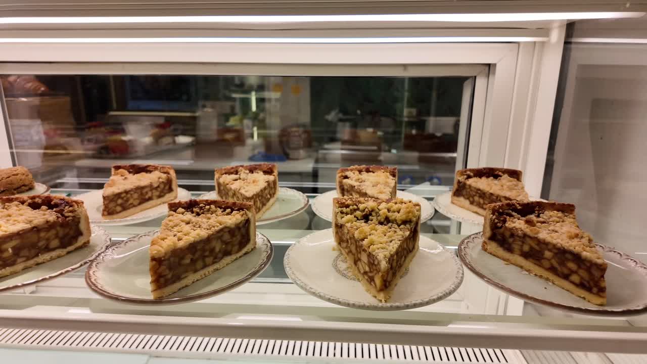Slices of Apple Crumble Pie in a Bakery Display Case