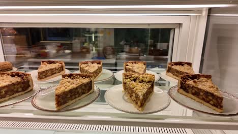 slices of apple crumble pie in a bakery display case