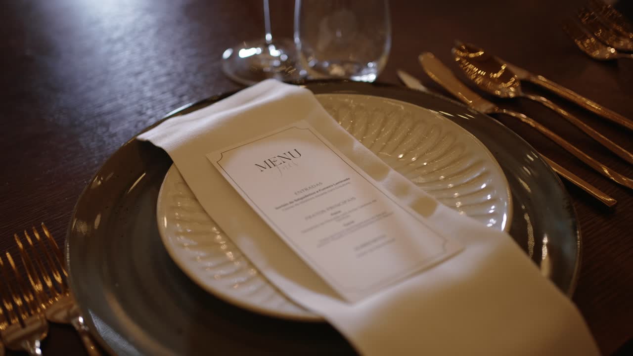 close up of formal table setting with printed menu and napkin