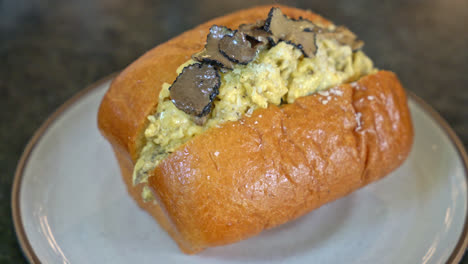 bun or bread with scrambled eggs and truffle mushroom