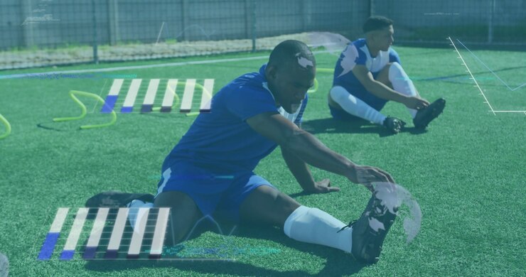 Soccer duo starting warmup on turf, lead player deepening pull on right foot, glitch map overlaying