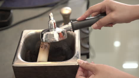 coffee grounds is discarded in a container.coffee grounds from coffee machines