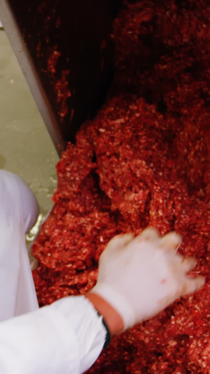 Butcher preparing minced meat